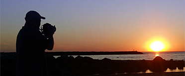 John photographing a sunset at the beach